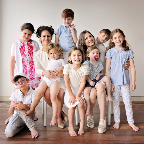 Two mothers sitting with their children